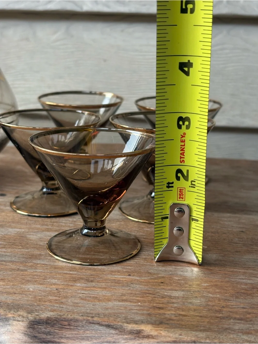 Art Deco decanter set features smoky purple glass adorned with a gold floral
